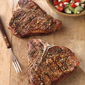 Greek-Seasoned T-Bone Steaks with Cucumber and Tomato Salad